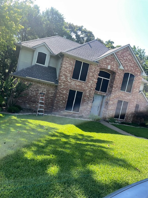 Solar screen installation on windows of a Texas home for energy efficiency